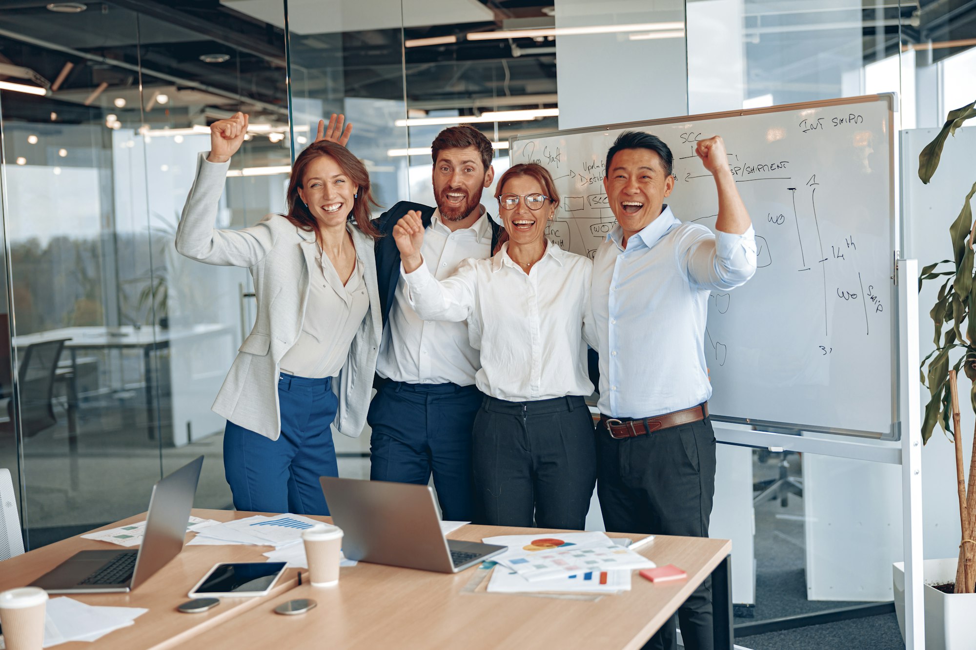 Smiling team posing for picture at workplace, motivated diverse colleagues together showing unity